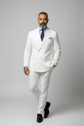 Man wearing white double-breasted dinner suit with peak lapels and tailored fit.